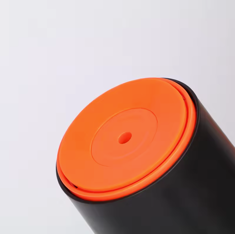 Close-up of the vibrant orange suction base on our custom double wall tumbler.